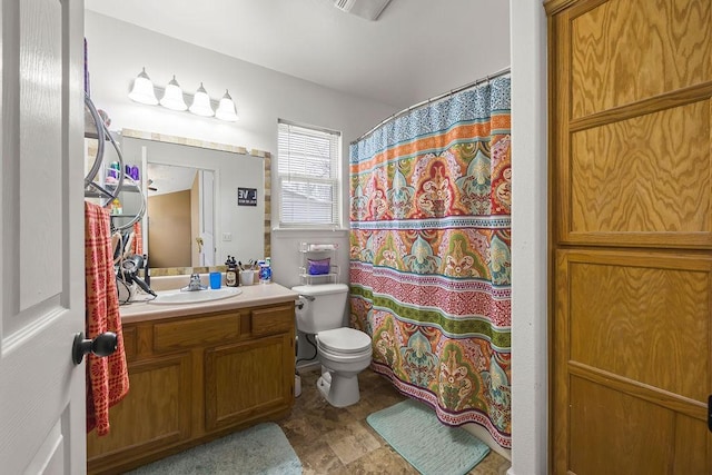 bathroom with toilet, a shower with shower curtain, and vanity