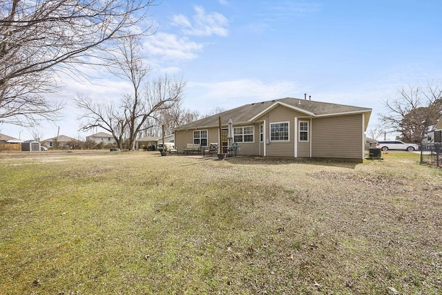 back of house featuring a yard