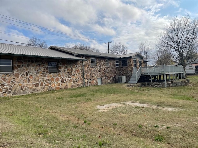 view of yard featuring stairway, central AC, and a deck