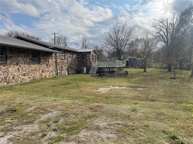 view of yard with cooling unit and a deck