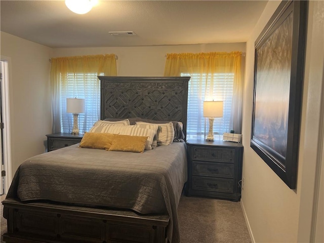 carpeted bedroom with visible vents and baseboards