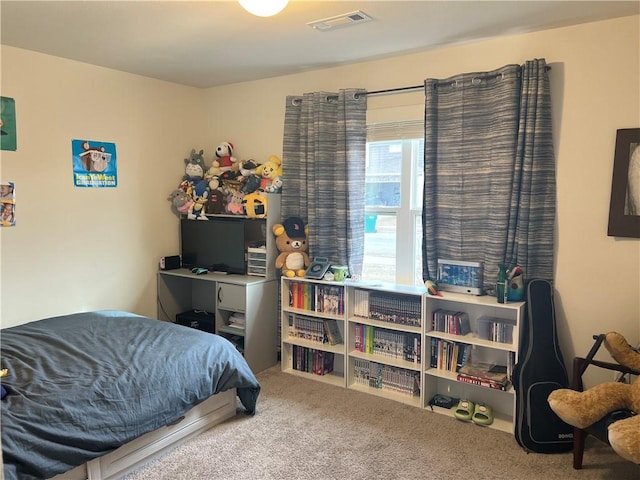 carpeted bedroom featuring visible vents