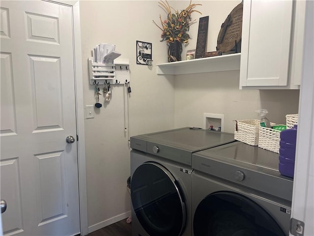 laundry room featuring baseboards, cabinet space, and washer and dryer