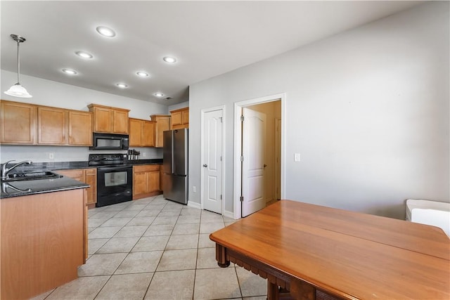 kitchen featuring black appliances, a sink, dark countertops, recessed lighting, and light tile patterned floors