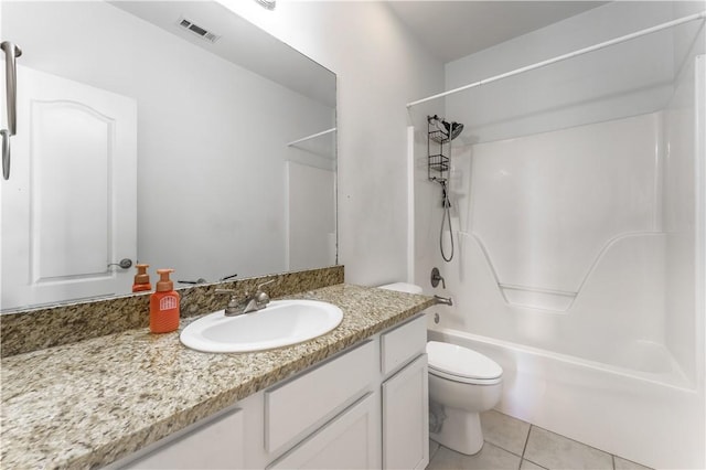 bathroom featuring tile patterned floors, visible vents, toilet, shower / washtub combination, and vanity