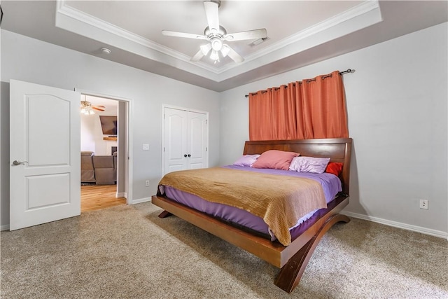 bedroom with light colored carpet, crown molding, a raised ceiling, and baseboards