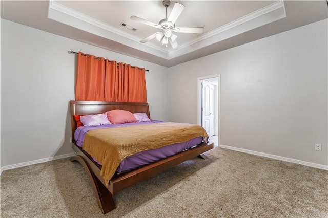 carpeted bedroom featuring visible vents, a raised ceiling, baseboards, and crown molding