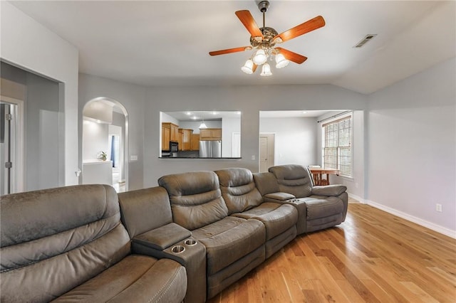 760 Napa Ave, Centerton, AR 72719 - living area featuring light wood-type flooring, ceiling fan, arched walkways, baseboards, and vaulted ceiling