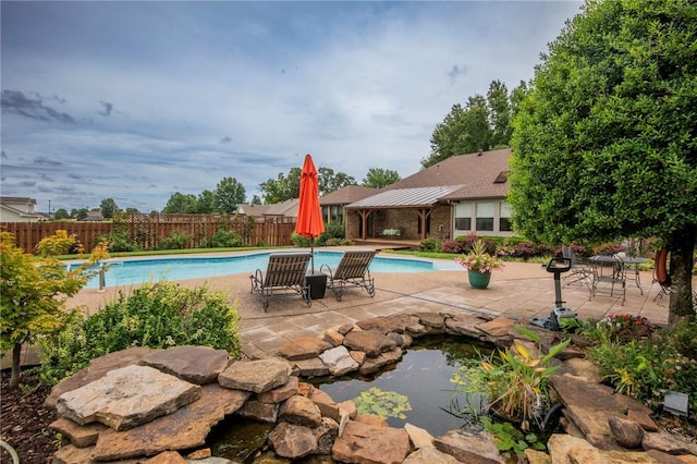 view of swimming pool featuring a fenced in pool, a patio, and fence