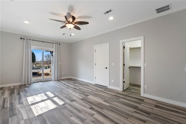 unfurnished bedroom with access to exterior, visible vents, crown molding, and baseboards