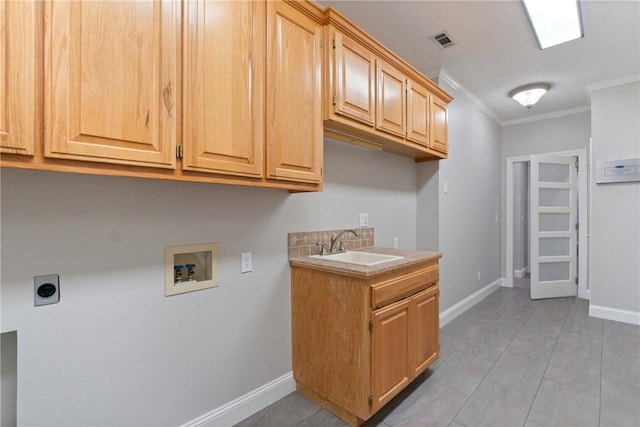 clothes washing area with cabinet space, visible vents, electric dryer hookup, washer hookup, and a sink