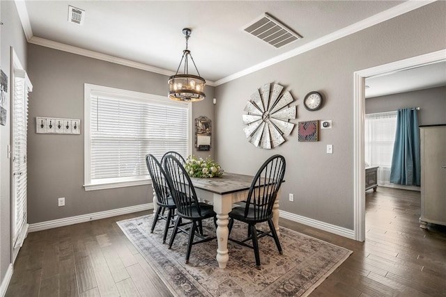 dining area featuring ornamental molding, dark wood finished floors, and visible vents