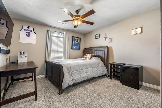 bedroom featuring baseboards, a ceiling fan, visible vents, and light colored carpet