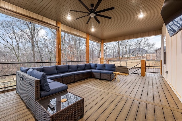 wooden deck with ceiling fan and an outdoor living space