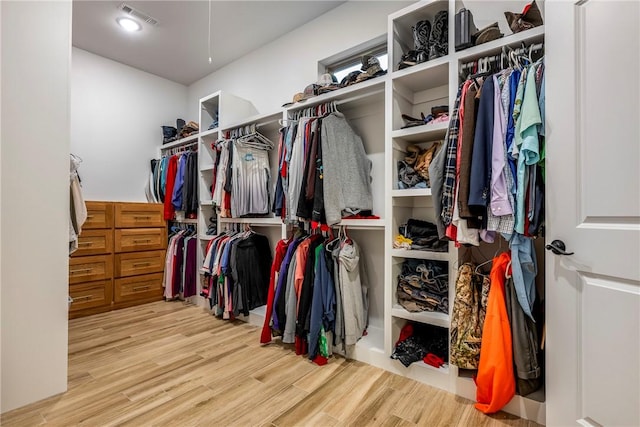 walk in closet with wood finished floors and visible vents