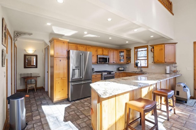 kitchen featuring tasteful backsplash, visible vents, high quality appliances, a peninsula, and beam ceiling