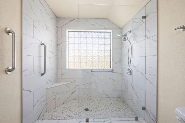 full bath with a shower stall and a textured wall