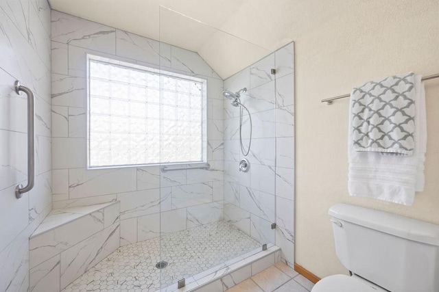 bathroom with toilet and a tile shower