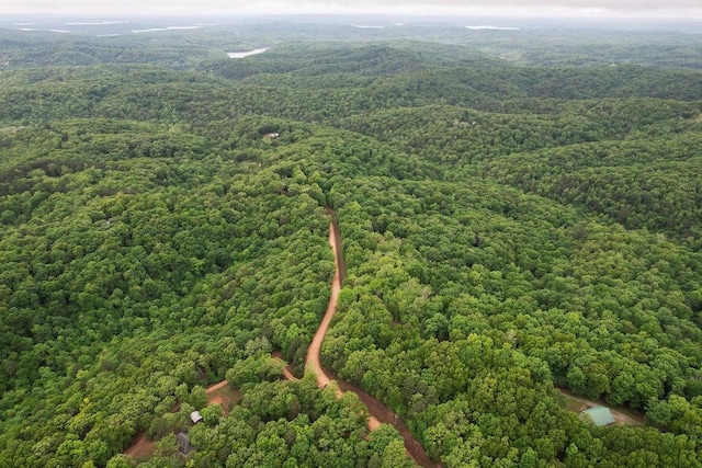 drone / aerial view featuring a forest view