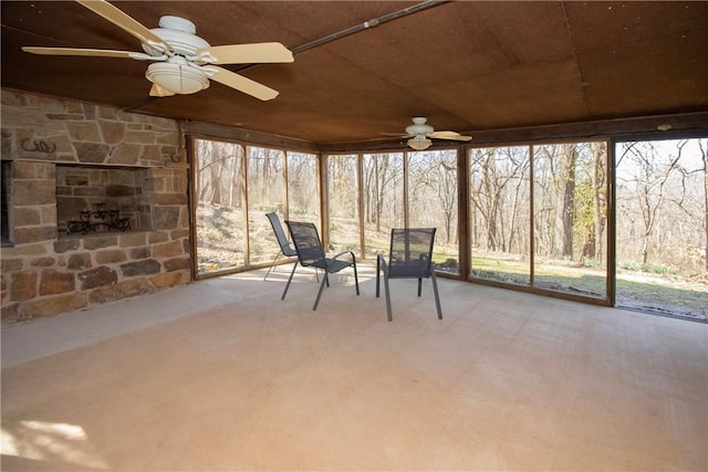 unfurnished sunroom with a ceiling fan