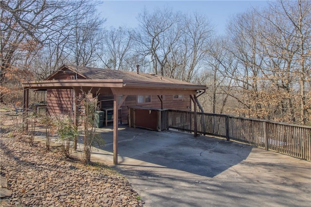 view of side of property with concrete driveway