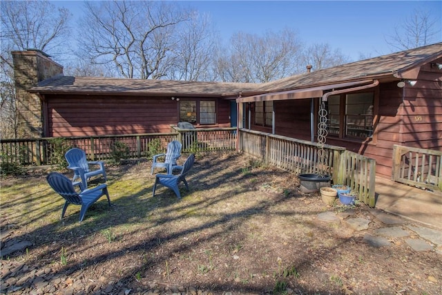 exterior space with a porch and a chimney