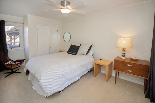 bedroom with baseboards, light colored carpet, and a ceiling fan