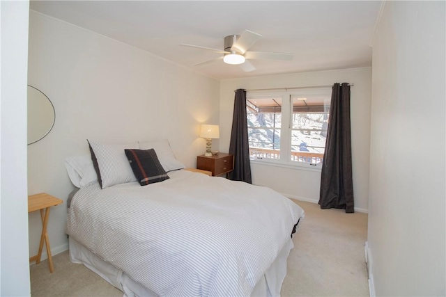 bedroom featuring baseboards, light carpet, and a ceiling fan