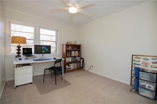 home office featuring ceiling fan, baseboards, and light carpet