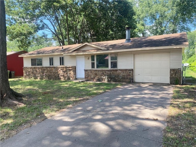 single story home featuring an attached garage, stone siding, driveway, and a front lawn