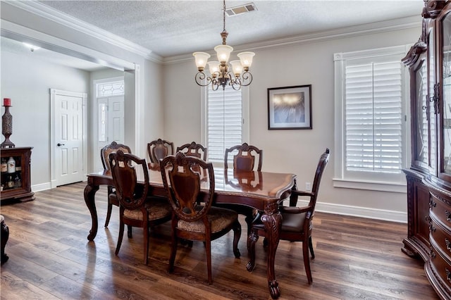 dining space with plenty of natural light, visible vents, and dark wood-style flooring