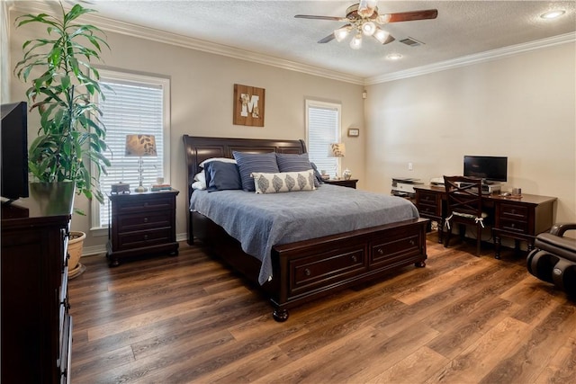 bedroom with ornamental molding, a textured ceiling, and wood finished floors