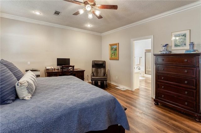 bedroom with visible vents, crown molding, baseboards, and wood finished floors