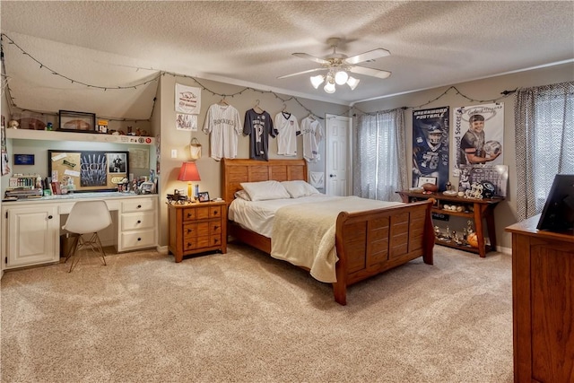 bedroom with a ceiling fan, light colored carpet, and a textured ceiling