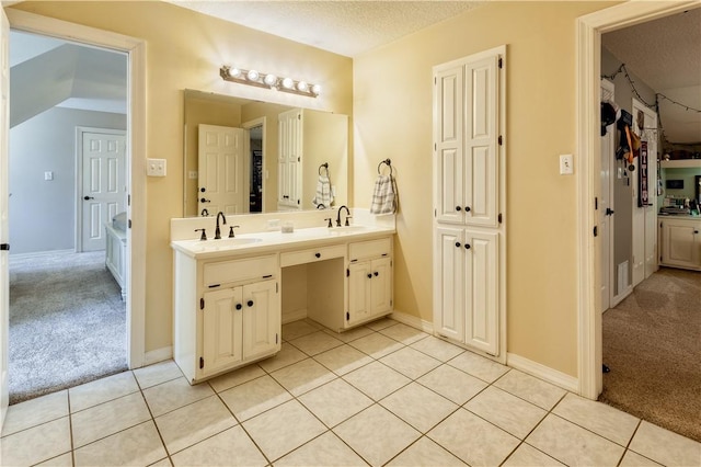 full bathroom featuring a textured ceiling, tile patterned flooring, visible vents, vanity, and a closet