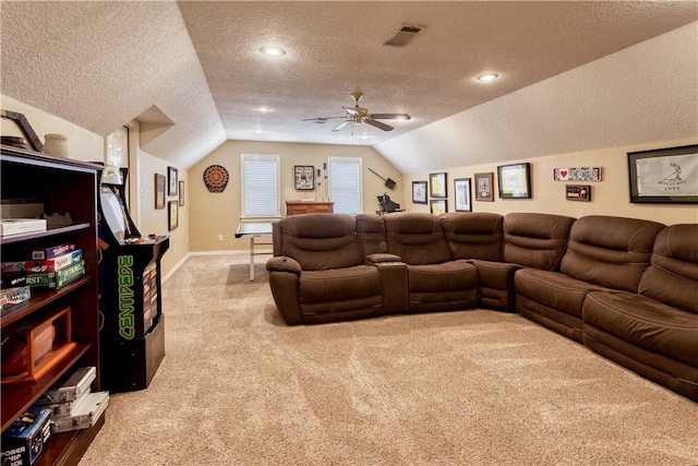 living area featuring lofted ceiling, a textured ceiling, carpet floors, visible vents, and baseboards