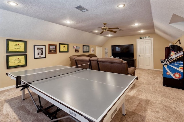 playroom with lofted ceiling, a textured ceiling, visible vents, baseboards, and carpet