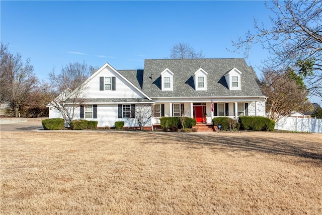 cape cod home featuring fence, a front lawn, and a porch