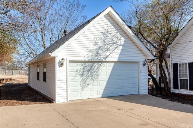 view of side of property featuring a detached garage and an outdoor structure