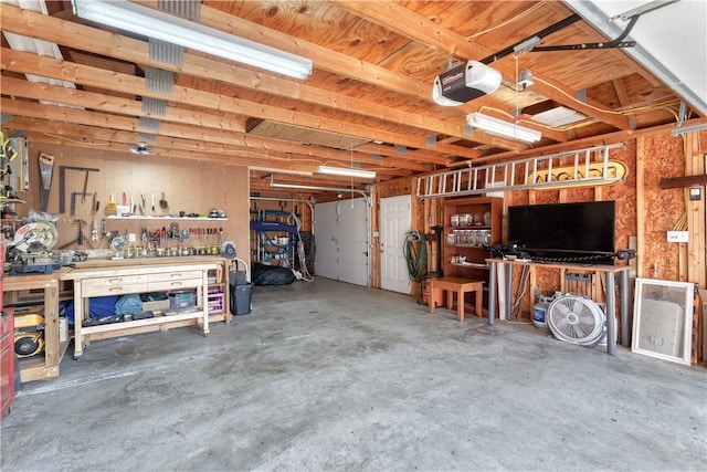 garage featuring a workshop area and a garage door opener