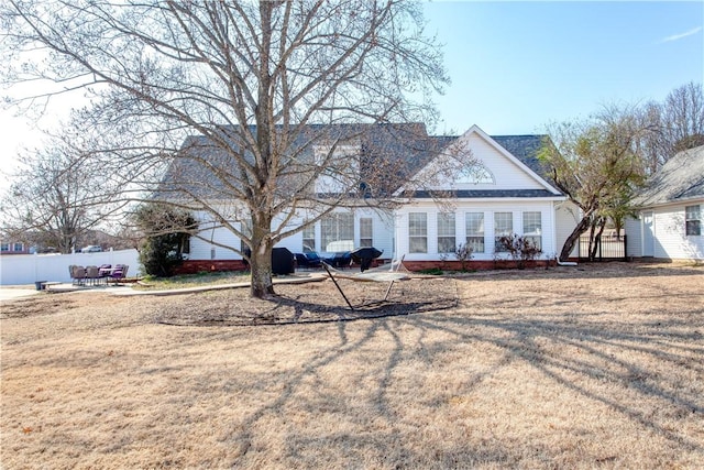 view of front facade featuring fence, a patio, and a front yard