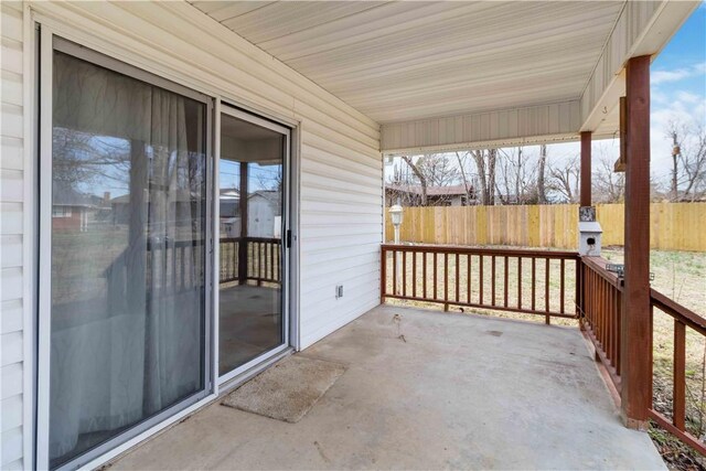 exterior space with covered porch and fence