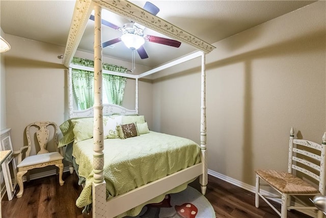 bedroom featuring ceiling fan, baseboards, and wood finished floors