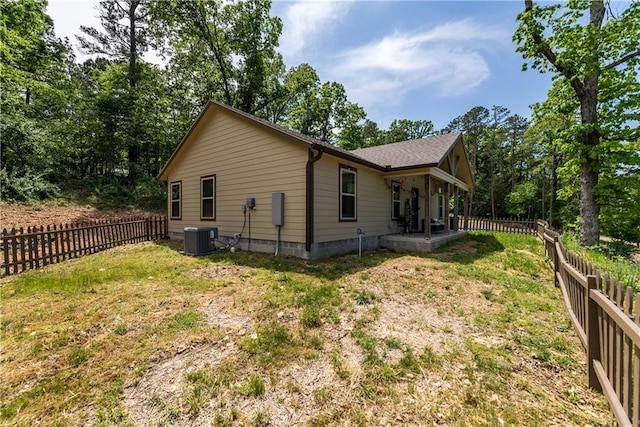 view of home's exterior featuring a yard, central AC unit, and a fenced backyard