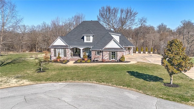 view of front of house featuring covered porch and a front lawn