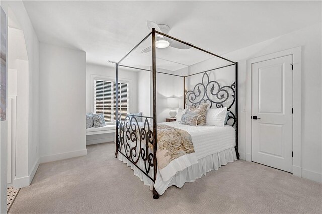 carpeted bedroom with a ceiling fan and baseboards