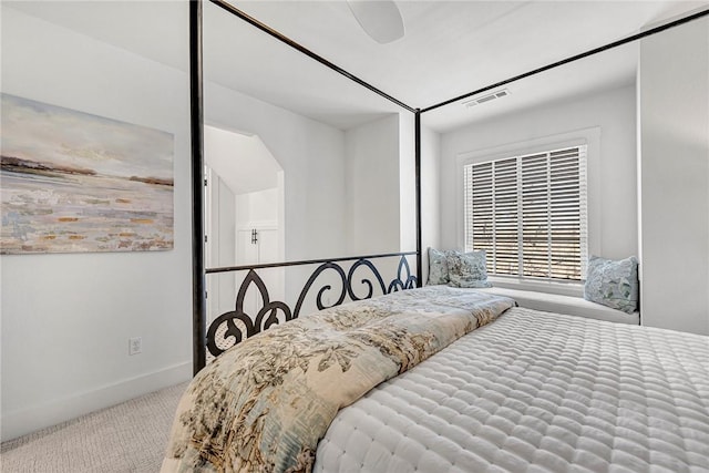 carpeted bedroom featuring visible vents, a ceiling fan, and baseboards