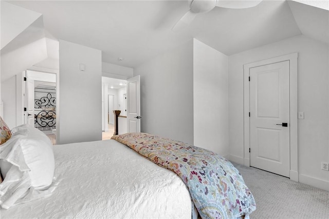 bedroom featuring light colored carpet, baseboards, and ceiling fan