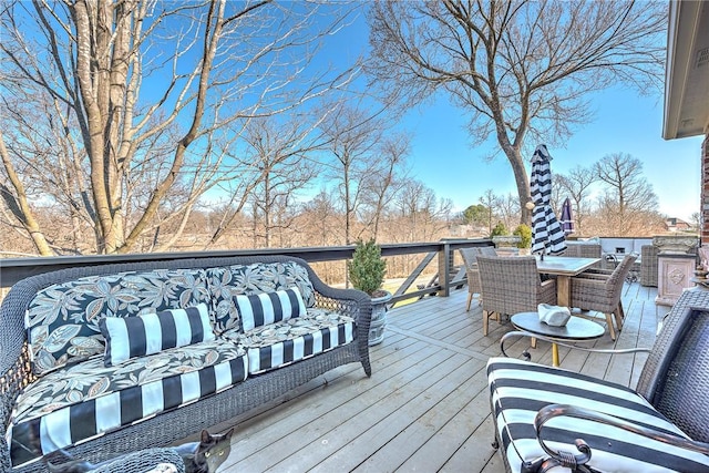 deck featuring outdoor dining space and an outdoor hangout area