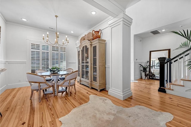 dining space with light wood-type flooring, visible vents, a chandelier, and stairs